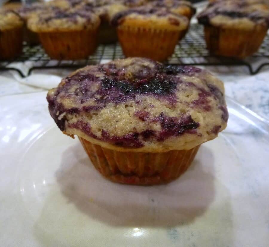 America's Test Kitchen's Best Blueberry Muffins feature whole berries stirred in, as well as blueberry compote and lemon sugar swirled into the tops. #americastestkitchen #lemon #blueberry #blueberrymuffins