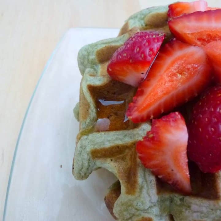 Top these matcha waffles with plenty of strawberries and maple syrup. #matcha #waffles #breakfast #brunch