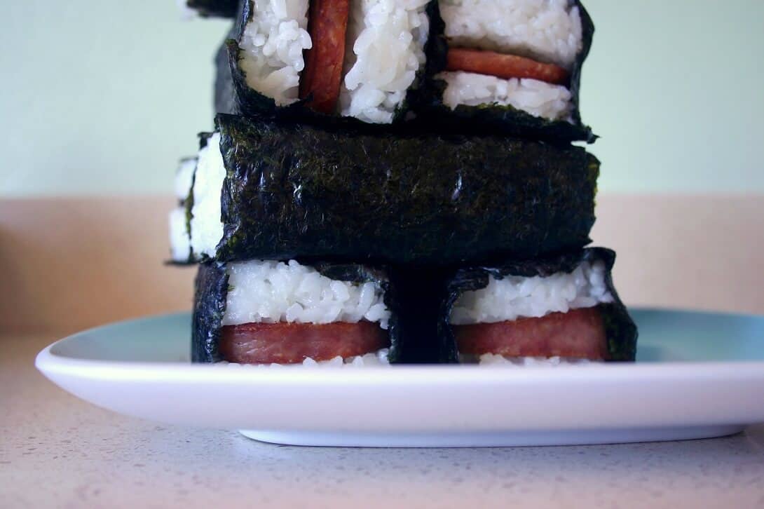 You may have queasy memories revolving the squishy meat product known as spam. But pan-fried, coated in teriyaki, and tucked into a rice and seaweed hug, it transforms into lunchtime hero spam musubi. #spammusubi #japanese #hawaiian #spam #rice #seaweed