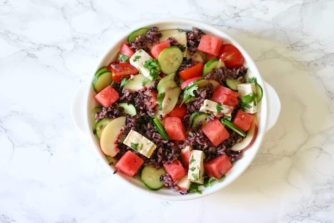 This summer fruit and tofu coconut forbidden rice is a great excuse to incorporate awesome summer fruit into dinner. #watermelon #nectarines #coconutmilk #forbiddenrice