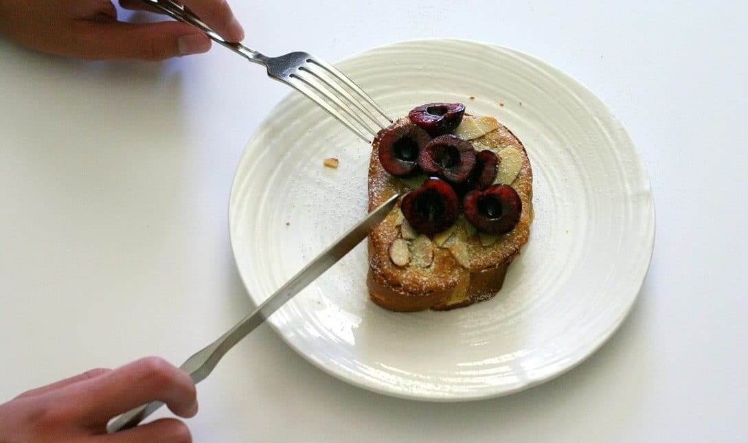 This almond cherry bostock can be eaten with a fork and knife, but it's equally as easy to pick it up and chow down. #cherry #almond #french #bostock #brunch