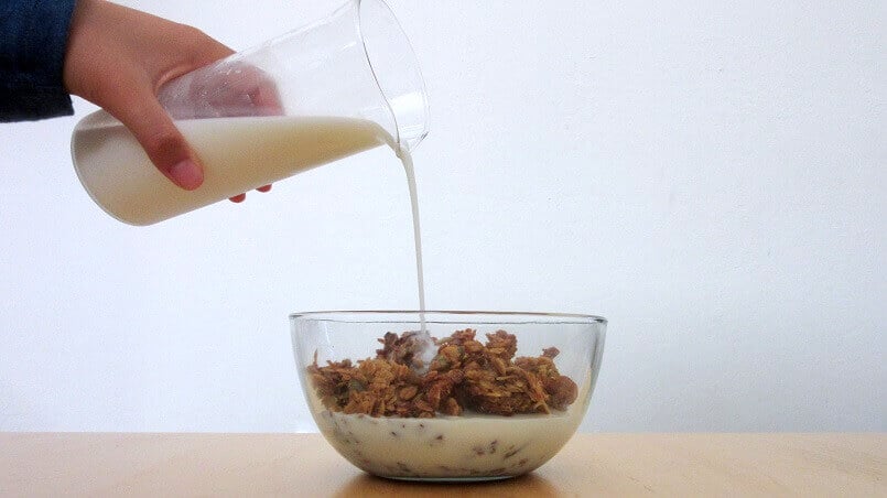 Milk being poured into a bowl of granola. #coconut #almond #granola #breakfast