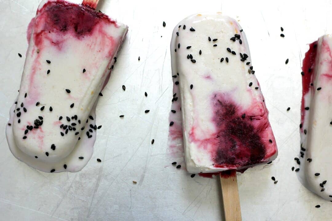 We're celebrating #popsicleweek with these coconut, blueberry and five spice popsicles with sesame seeds! #coconutmilk #blueberries #fivespice #blacksesameseeds #popsicles