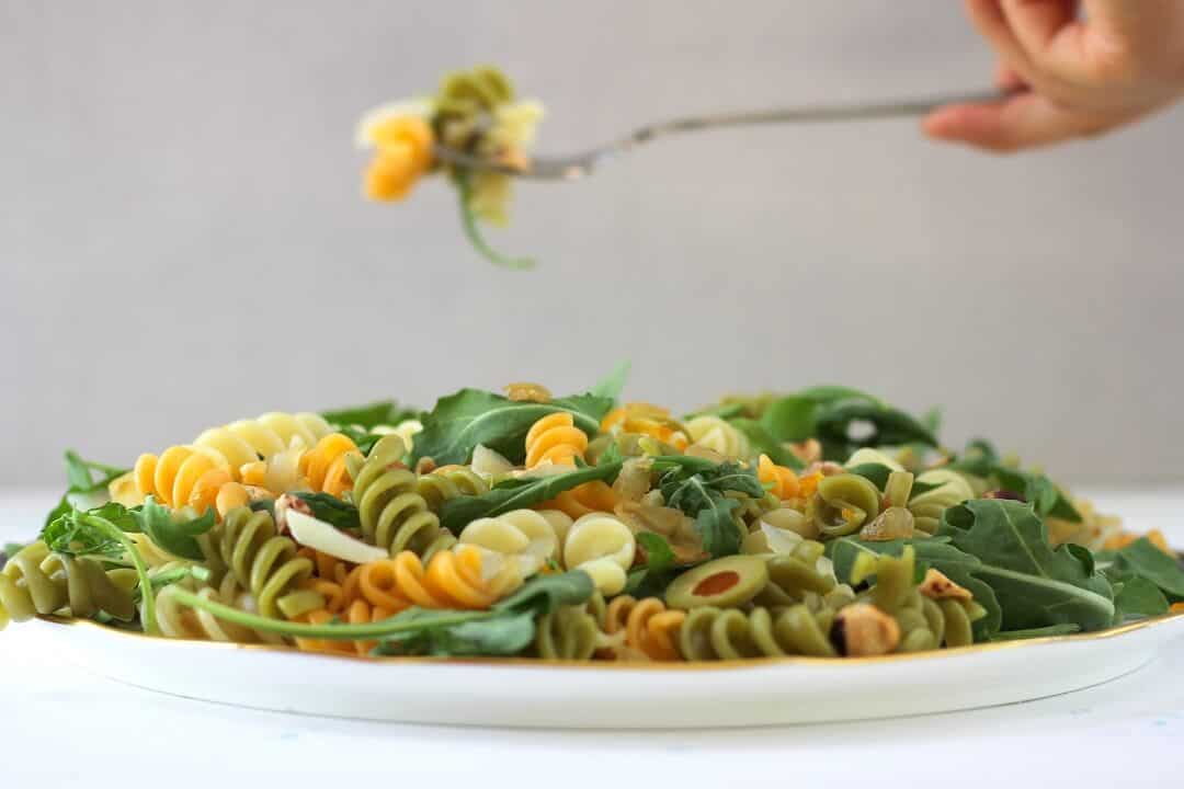 This olive pasta with kumquat vinaigrette is the kind of addictive that has you eating a bite straight from the serving dish. #olives #pasta #pastasalad #arugula #preservedlemon