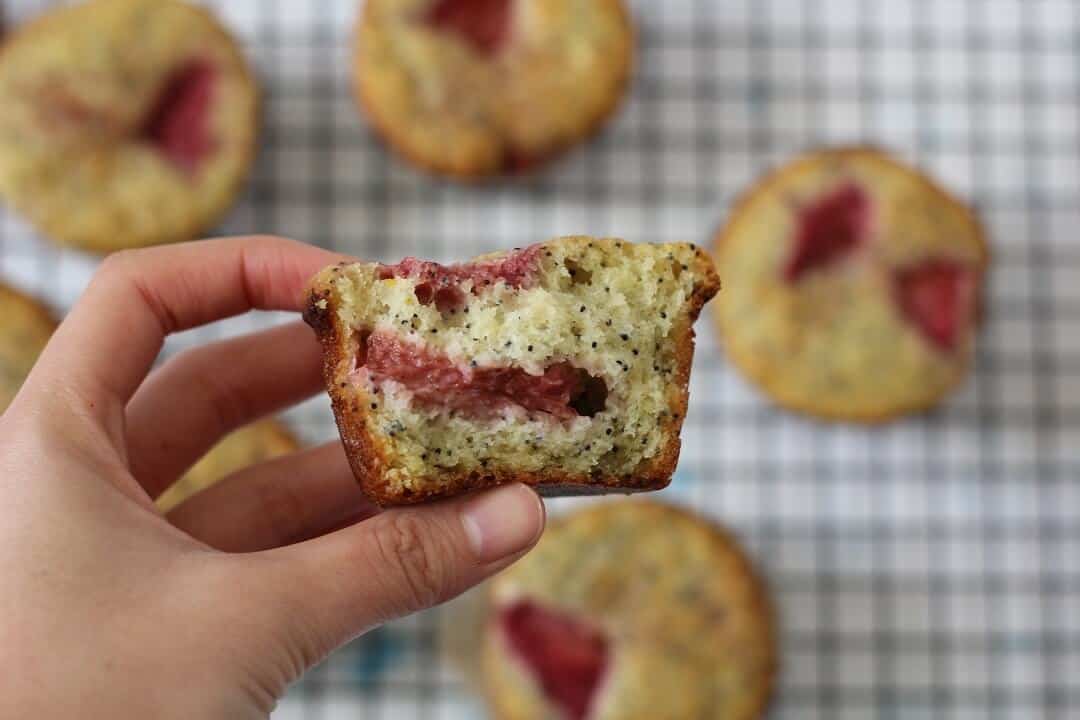 Cross section of a fluffy, tender strawberry lemon poppy seed muffin. #strawberry #lemon #poppyseed #muffins #lemonpoppyseedmuffins