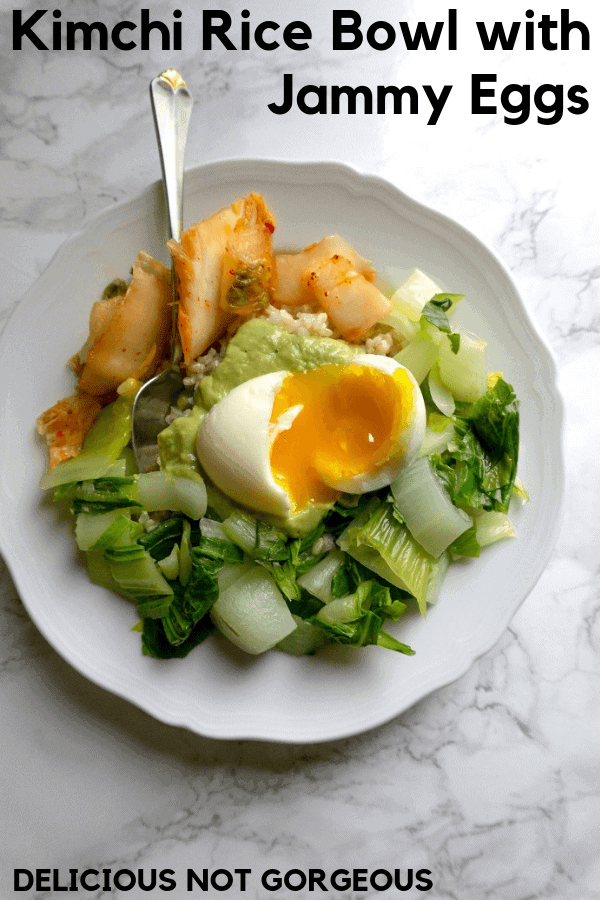 This kimchi rice bowl is a great lunch, full of nutty brown rice, sauteed bok choy, crunchy tangy kimchi, soft-boiled egg and avocado sauce. #kimchi #ricebowl #lunchideas #runnyeggs