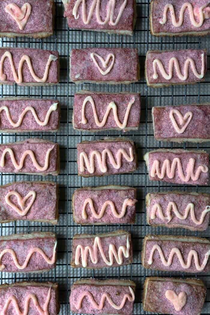 These raspberry strawberry cookies have three layers of buttery, shortbread goodness: raspberry, almond and strawberry. #shortbreadcookies #cookies #valentinesday #raspberry #strawberry