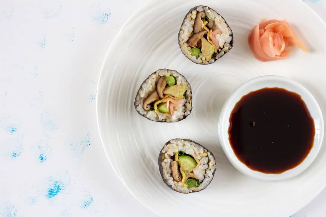 This shiitake mushroom and avocado sushi is so flavorful you could eat it plain, but a touch of soy sauce and more pickled ginger on the side doesn't hurt! #mushrooms #avocado #sushi #vegetarian