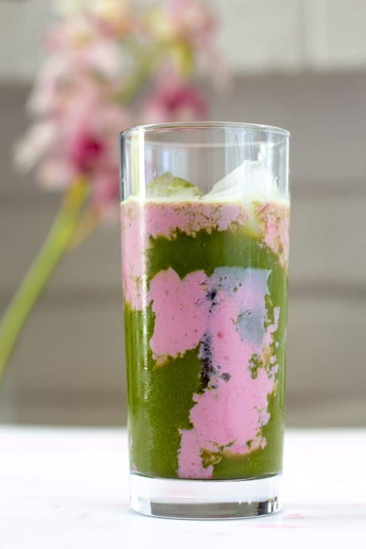 This matcha rose latte has layers of bright green matcha and creamy pink rose milk.