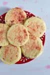 These pale cream-colored sugar cookies are dusted with bright pink crushed freeze-dried strawberries and sugar.
