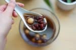Hong dou tang is a category of tong sui, or sweet Chinese soups. This one has sweet red beans, and unfilled tong yuen (think chewy mochi balls!).