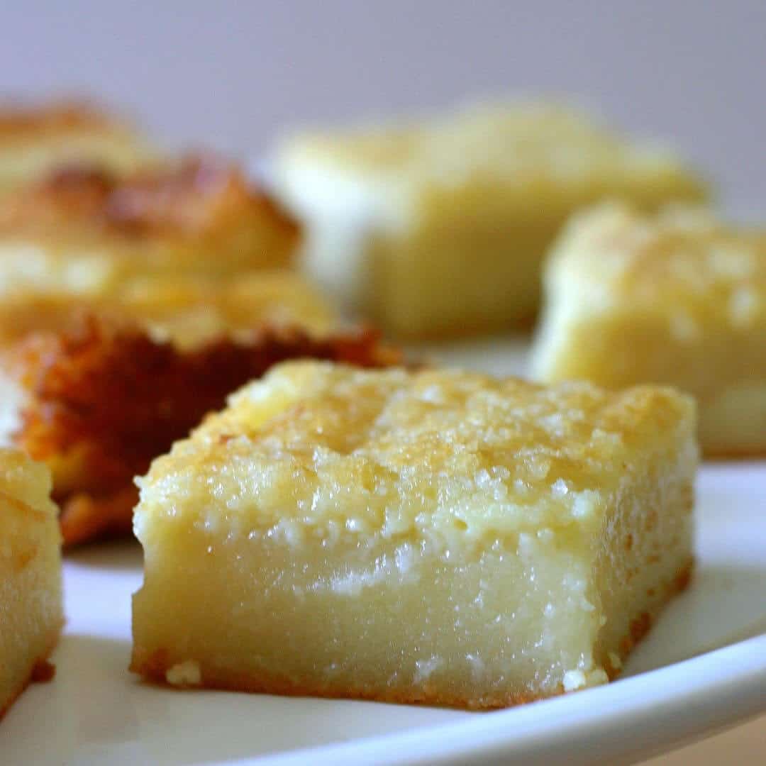 Square of golden yellow mochi with crispy, crumbly top.