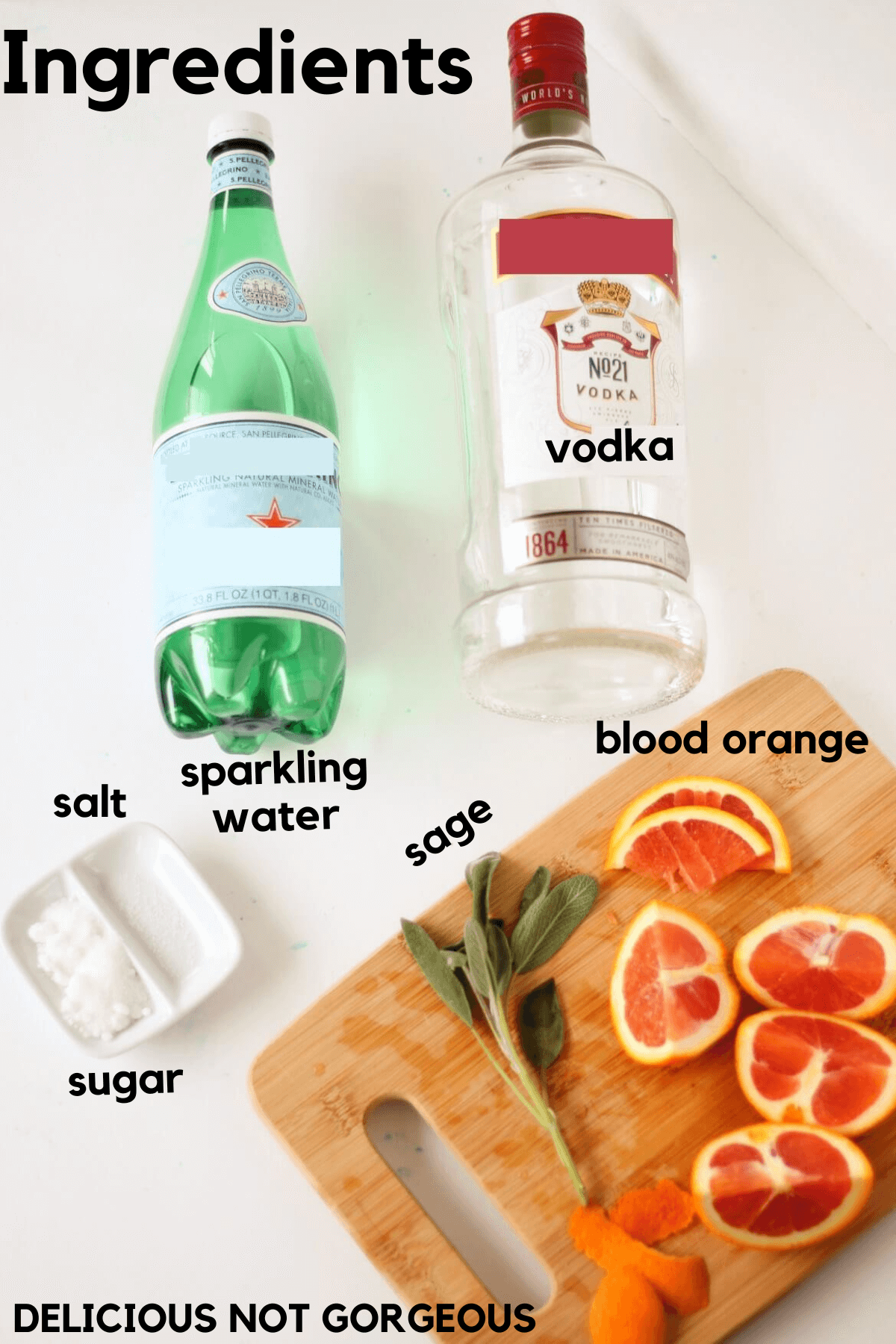 Ingredients laid out, including a green plastic bottle of sparkling water, a glass bottle of vodka, sliced blood oranges, sage leaves, blood orange peel, sugar and salt.